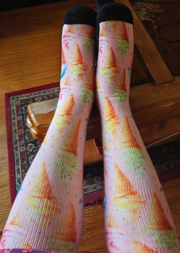 Customer's feet wearing pink Viasox EasyStretch socks featuring a colorful ice cream cone pattern.